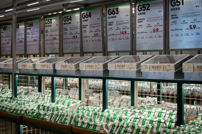 Shelves of produce with signs in a market